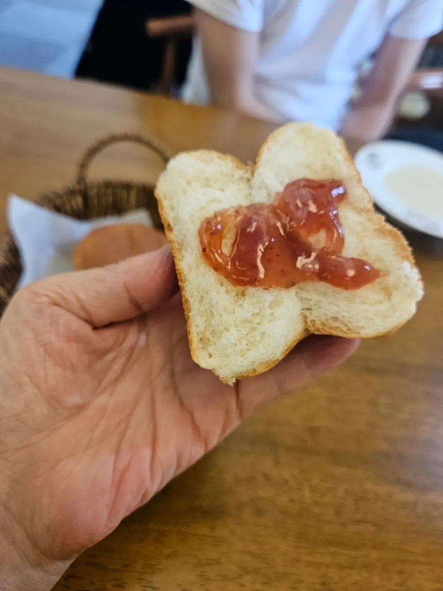 Warm morning bread spread with jam