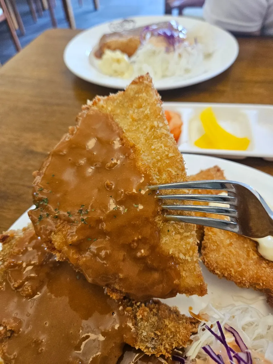 A piece of pork cutlet with crunchy cabbage salad