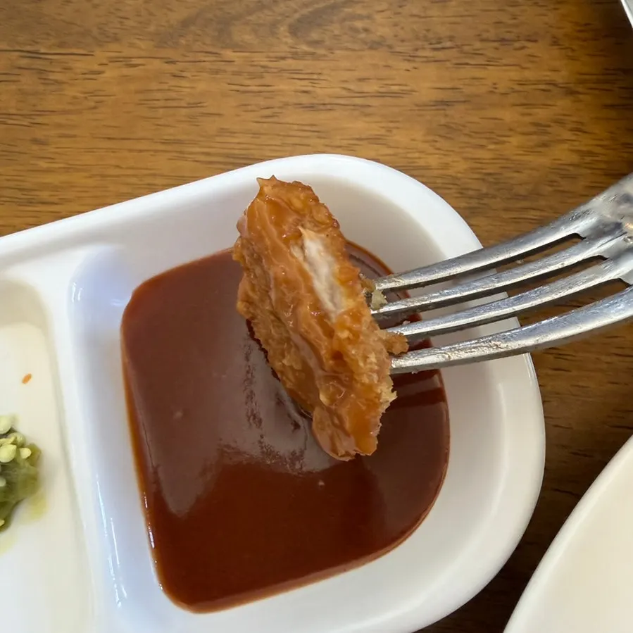 A piece of cutlet topped with chili relish