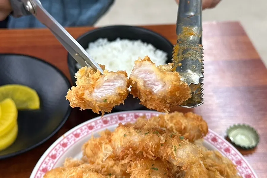 Breaded sweet and sour pork dipped in sauce
