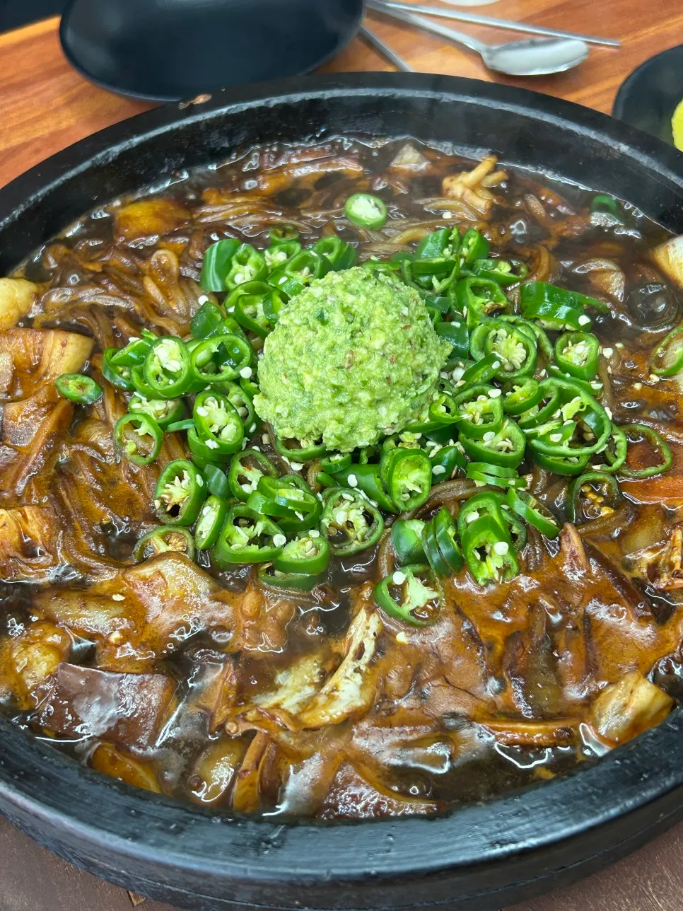 Spicy pesto stone-plate jajangmyeon sizzling on the hot plate