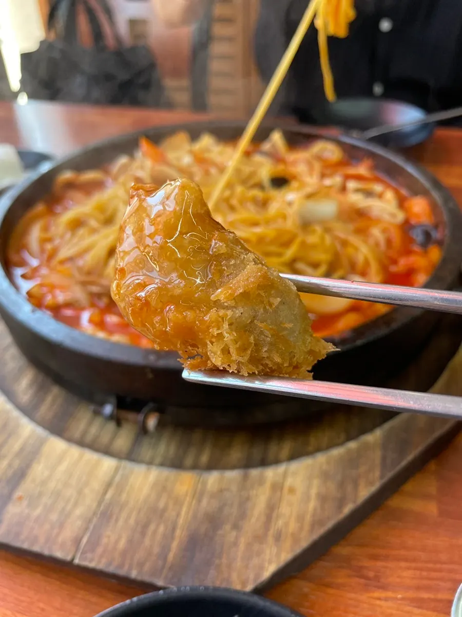 Dol jjamppong broth with bean sprouts stirred in