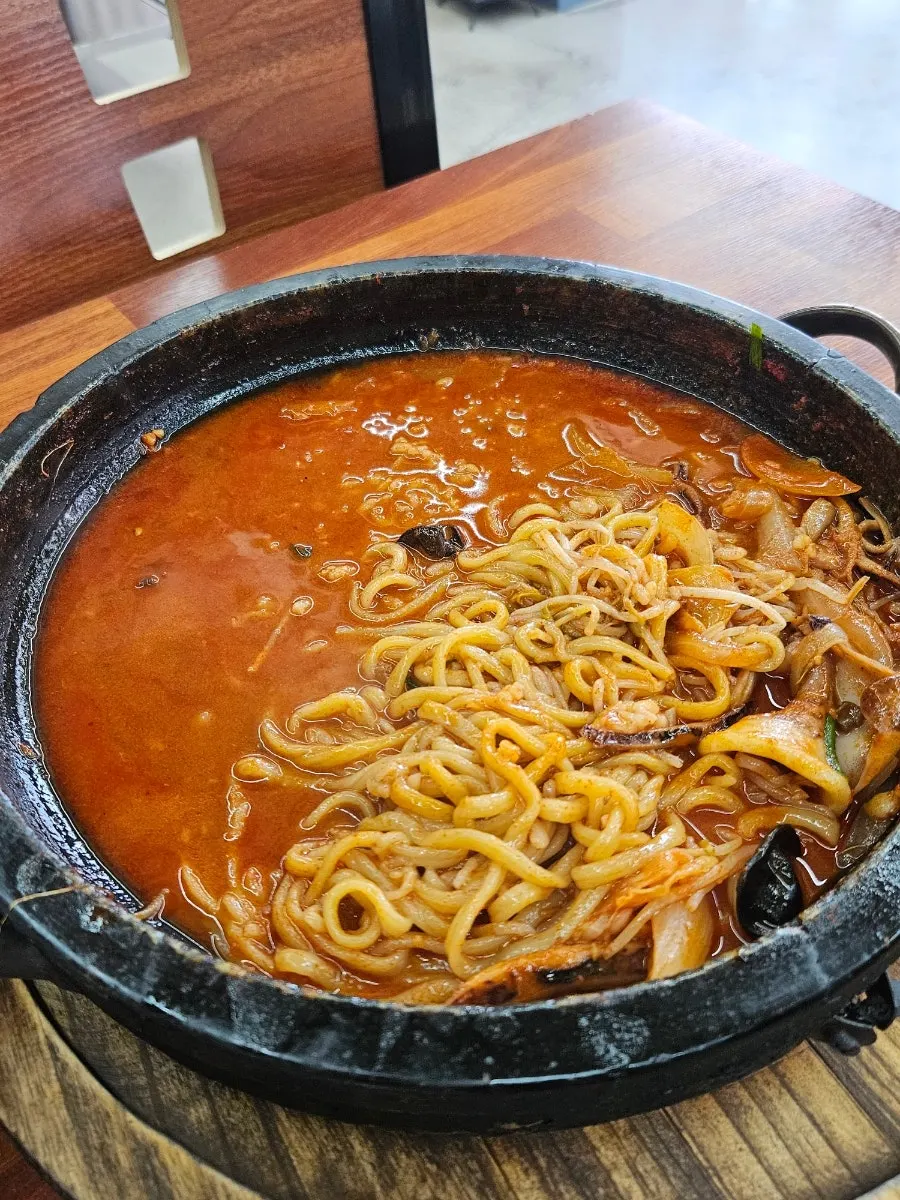 Close-up of the stone-plate jjamppong packed with seafood