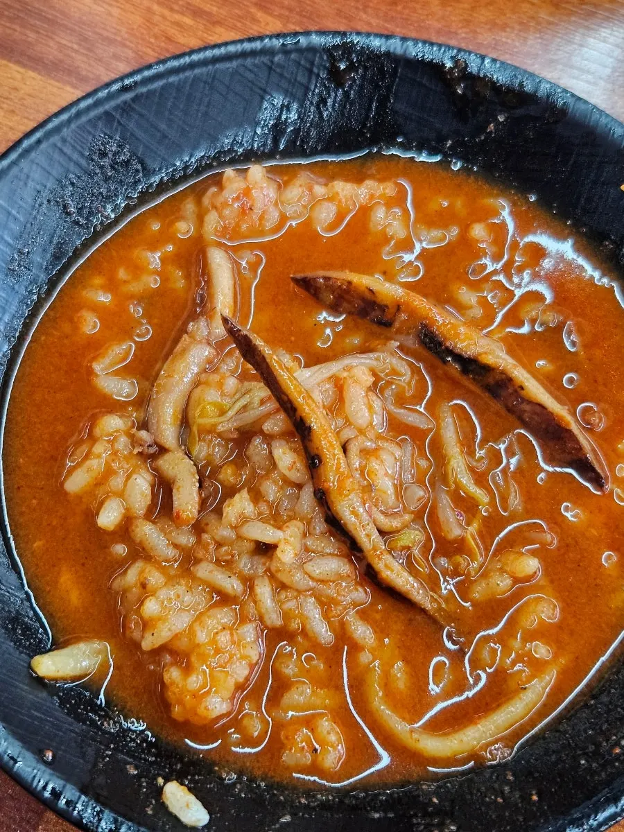 Scorched rice scraped from the bottom of the stone plate with a spatula