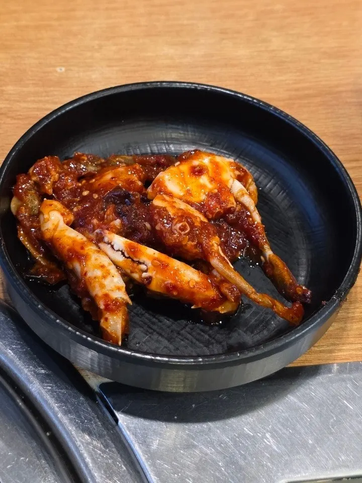 Seasoned crab side dish and a bowl of rice