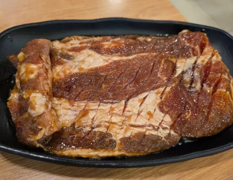 Plate of raw scored seasoned pork galbi