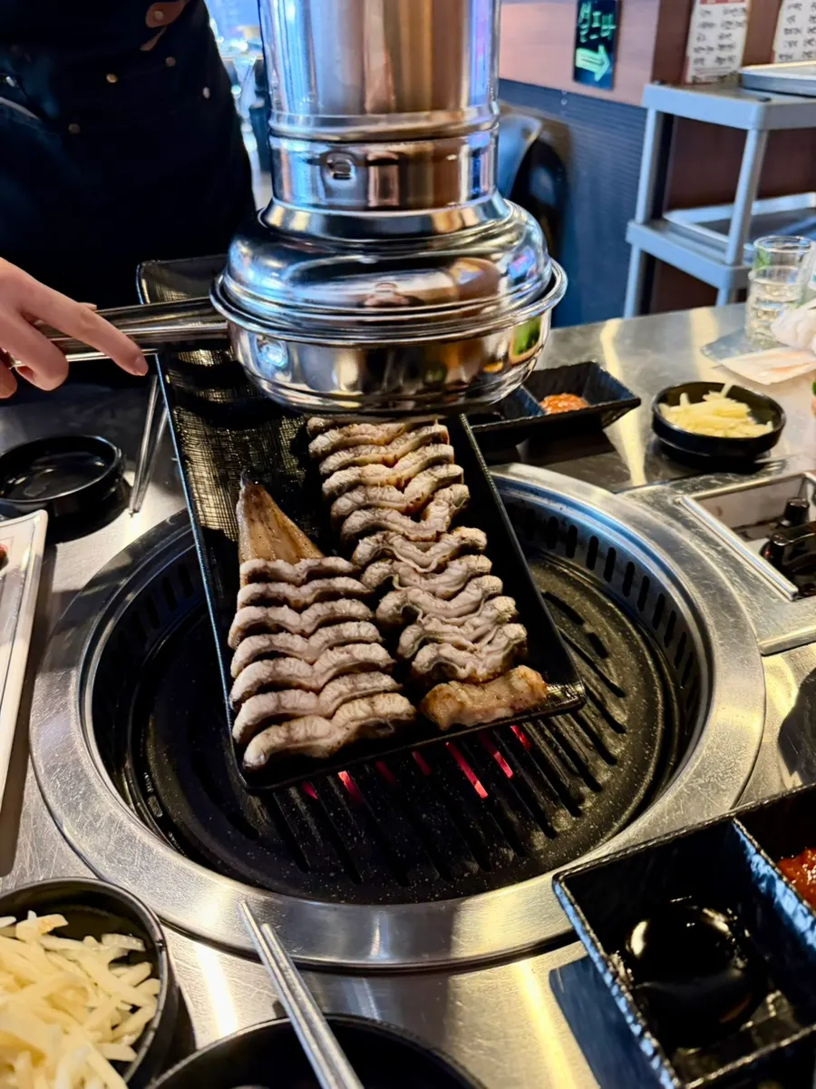 Eel pieces standing upright on the grill
