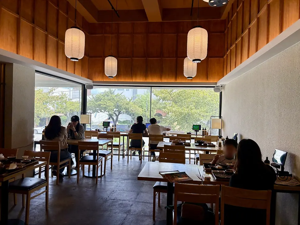 2nd floor table seats lit by sunlight through full windows