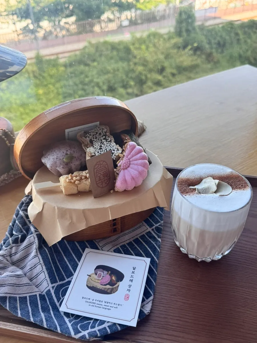 Tea and traditional desserts set on a window-side table