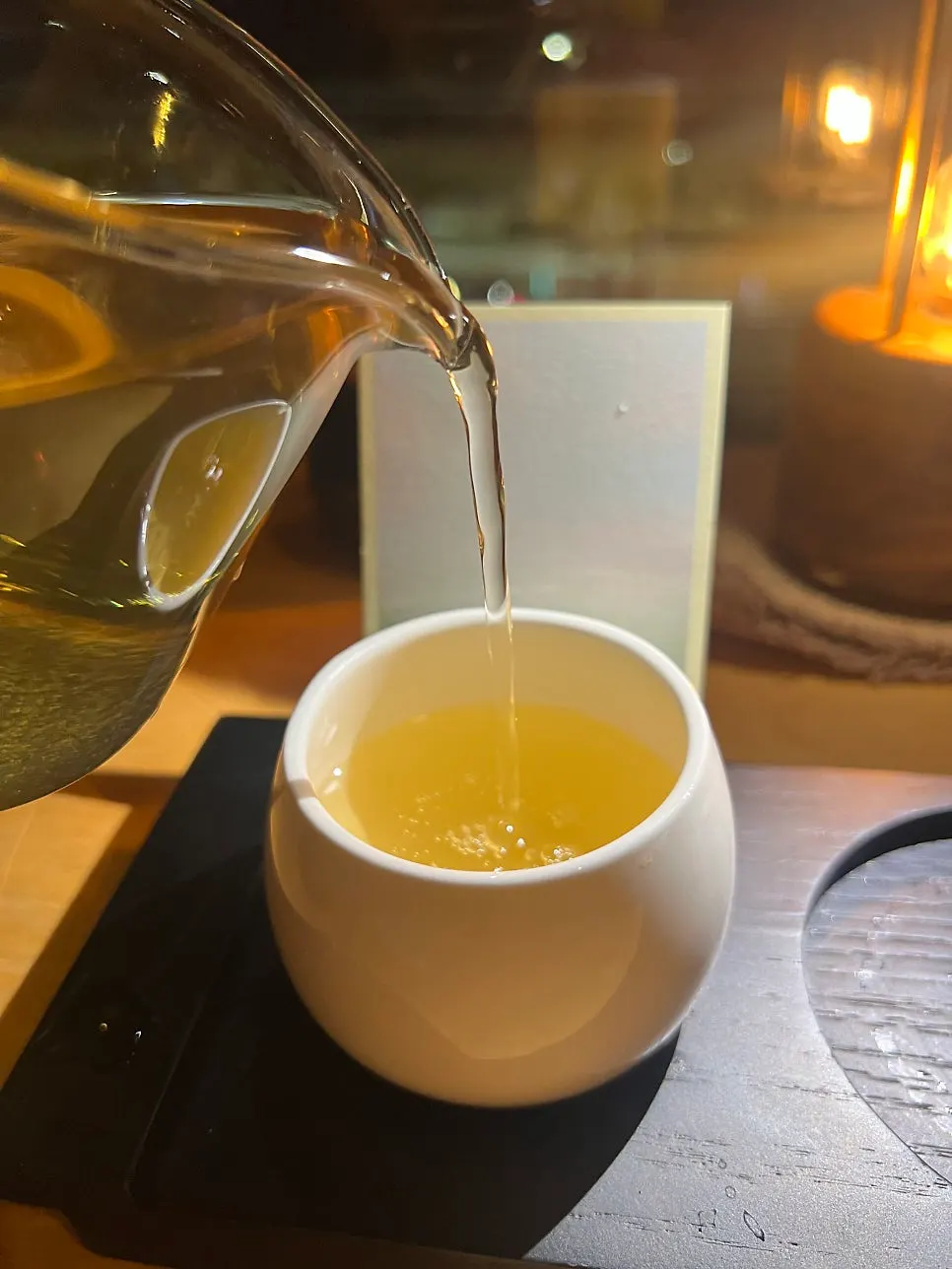 A warm cup of tea with the night sea in the background