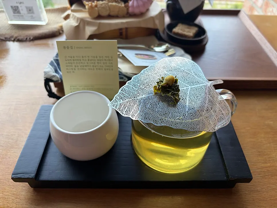 Tea and sweets set on a window-side table at Suwolgyeonghwa