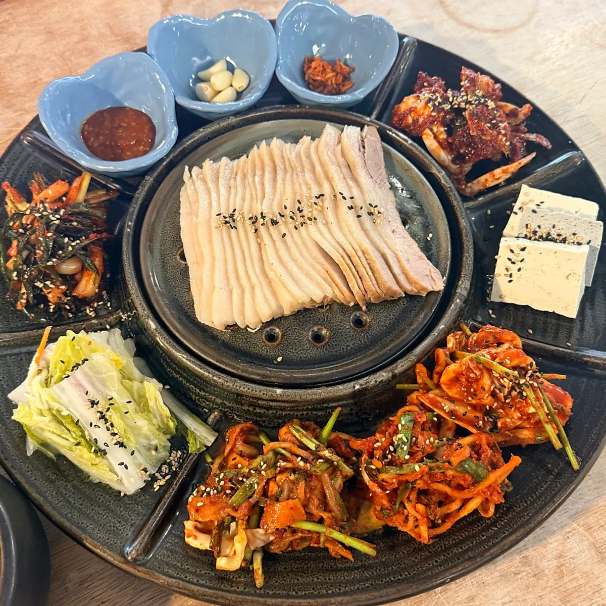 Salad, wrap vegetables, stir-fried squid, and doenjang jjigae spread
