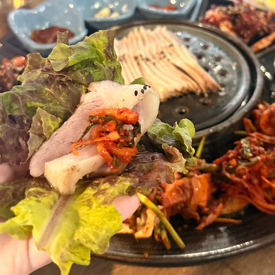 Spicy soy crab with tofu kimchi, scallion, white, and radish kimchi