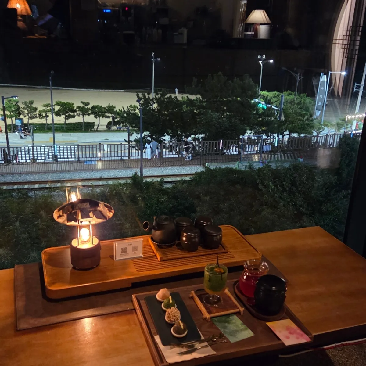 Table set at a window seat overlooking the night sea