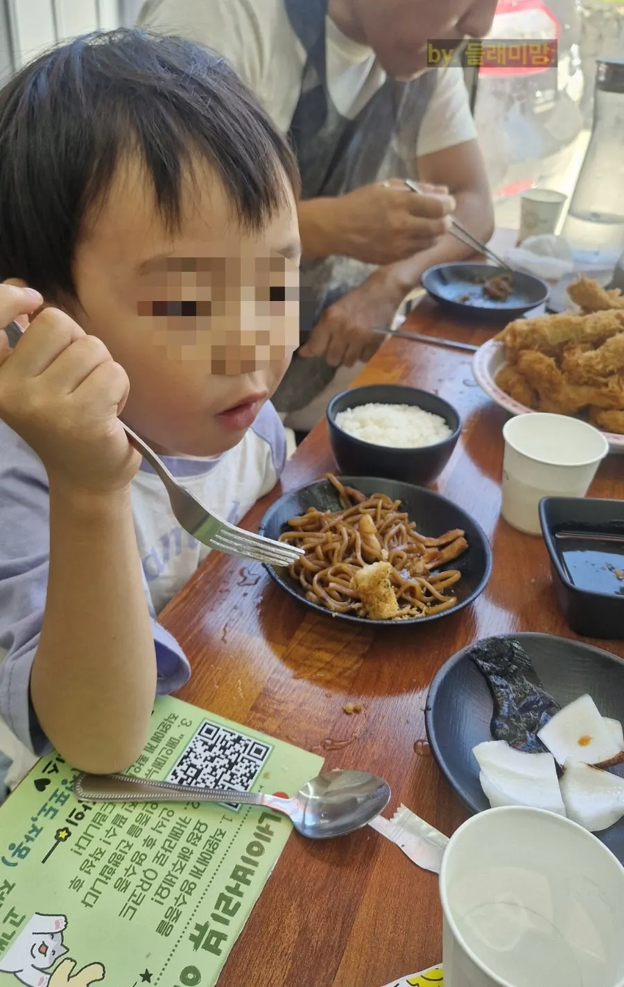 A child and grandmother eating together