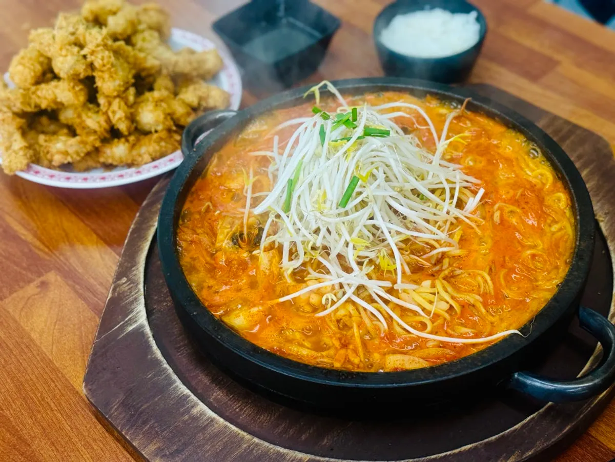 Self-serve side dish corner with green onion kimchi