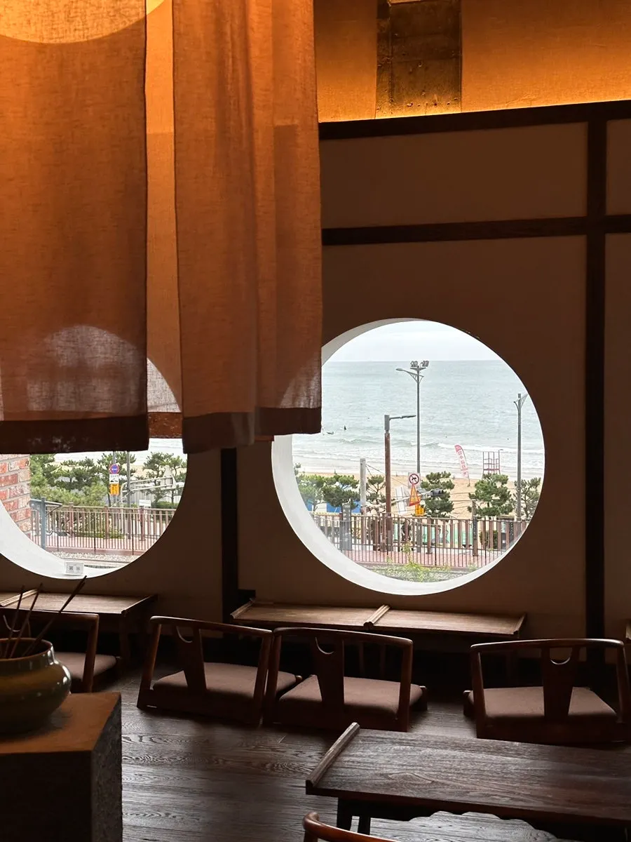 Bar seats facing the sea and floor seating area