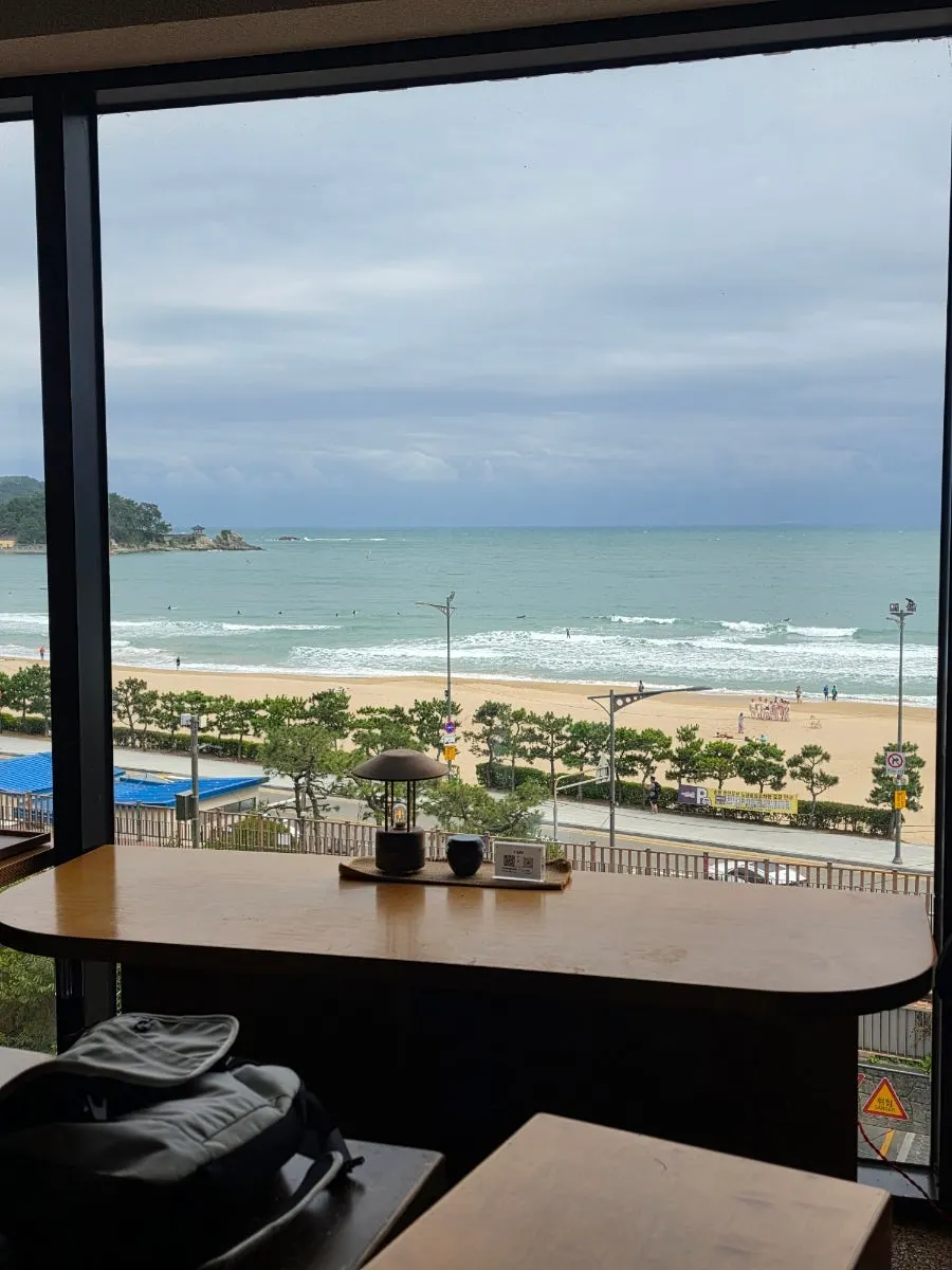 4th-floor window seat overlooking Songjeong Beach