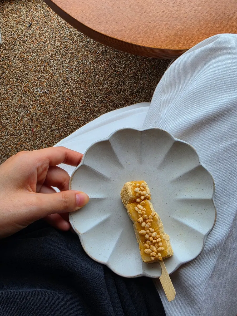 Injeolmi skewer topped with soybean powder and puffed rice