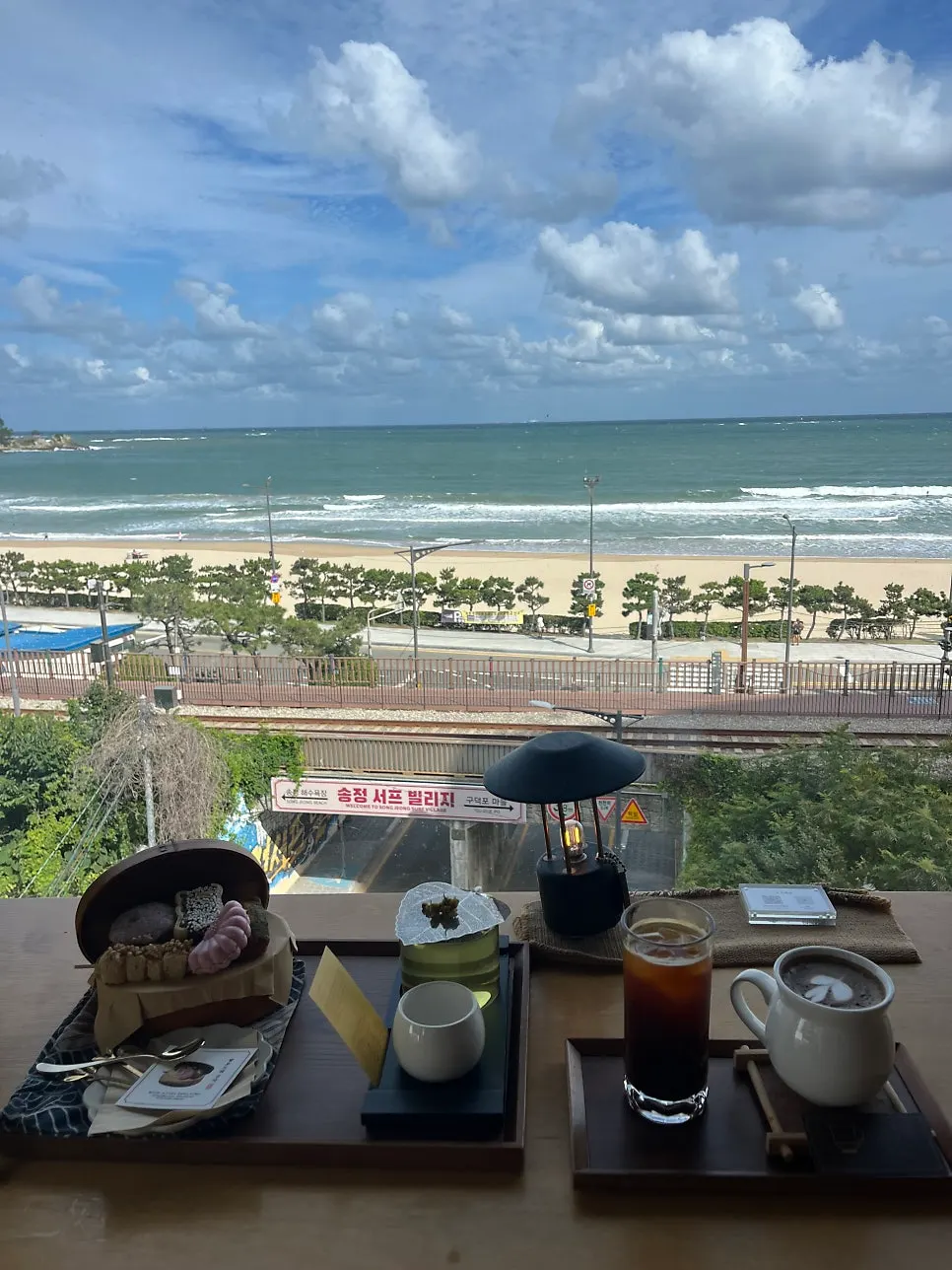 View of Songjeong Beach and the beach train from Suwolgyeonghwa's window seat