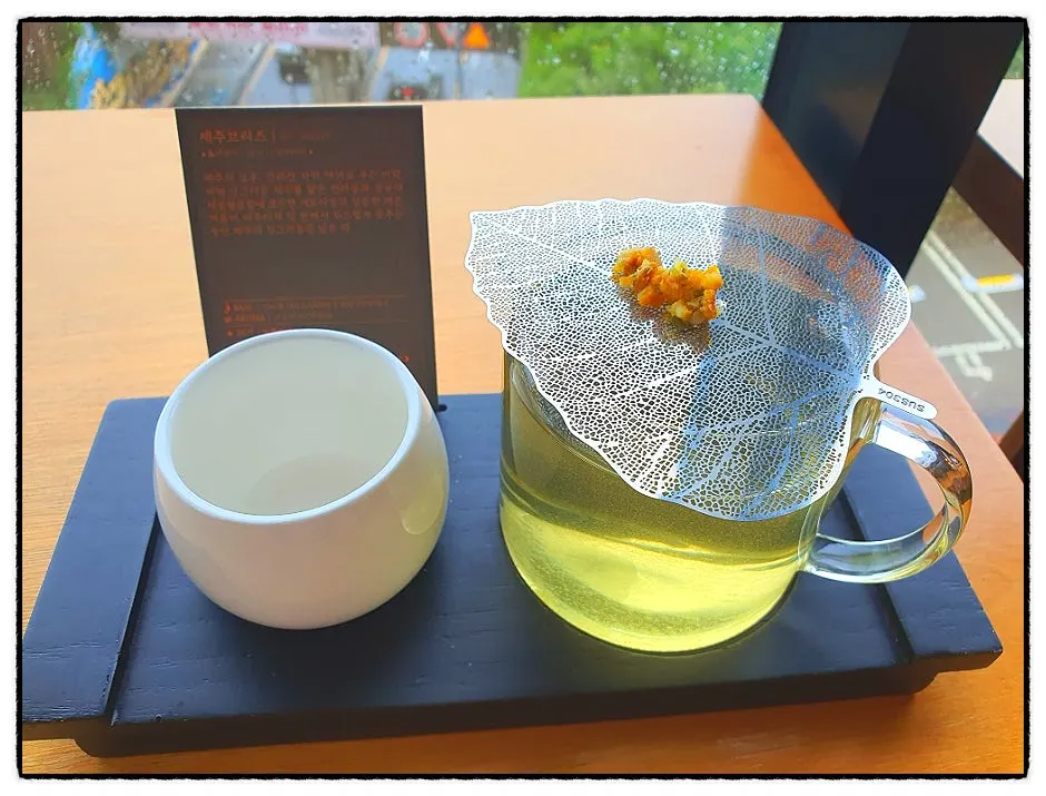 Jeju Breeze tea served with a leaf coaster on top