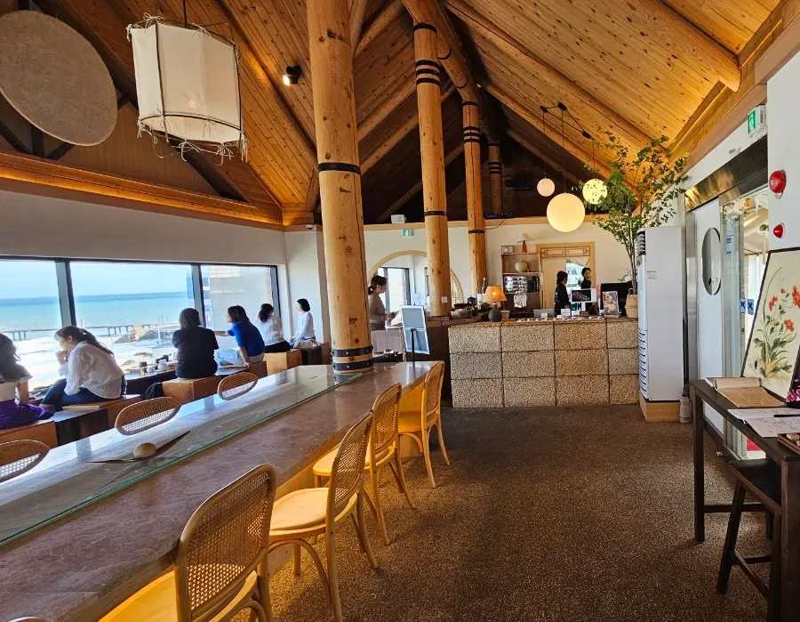 Interior of Suwolgyeonghwa with wood tones and Korean elements
