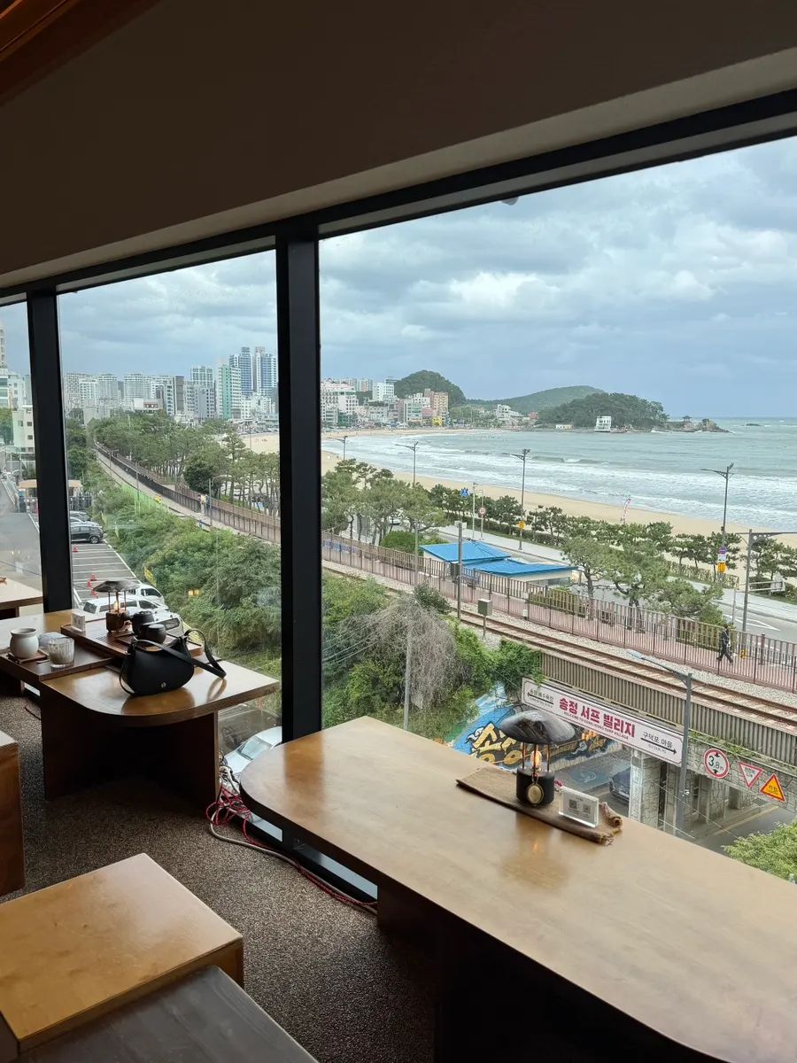 Ocean view of Songjeong Beach through the wide windows of Suwolgyeonghwa's 4th floor