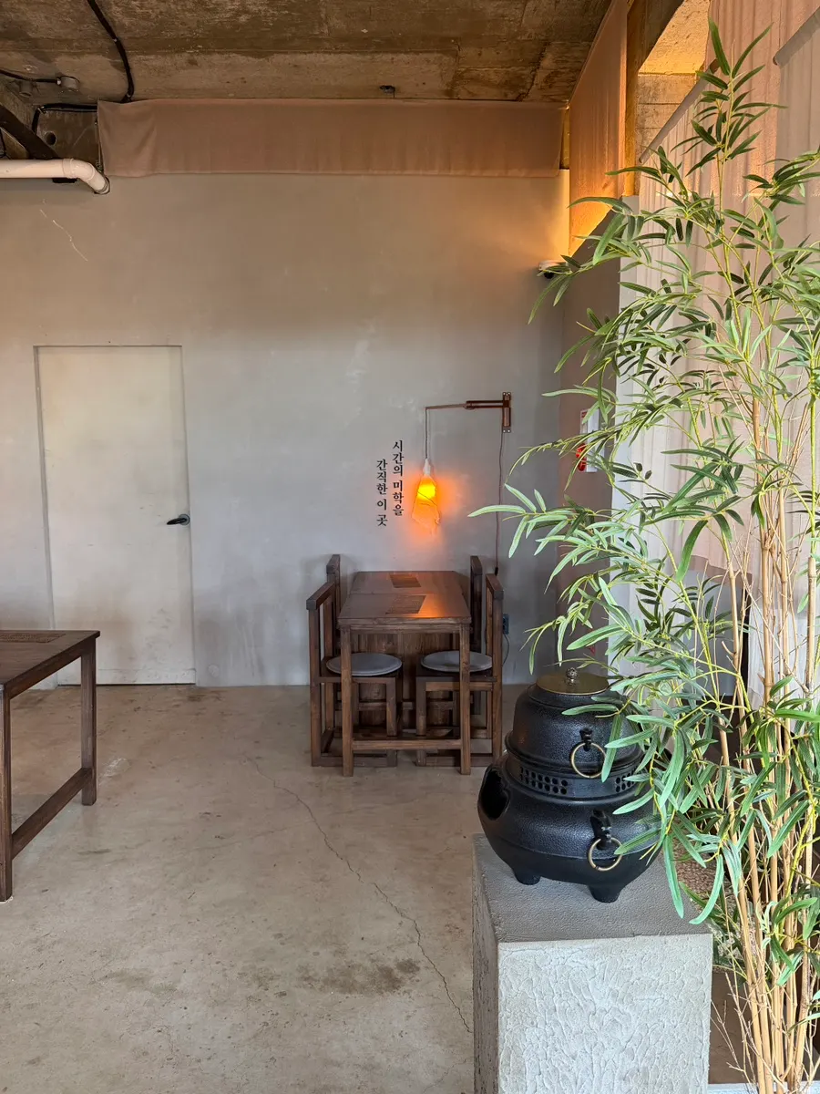 Wooden furniture and thin curtains in the 3rd-floor seating area