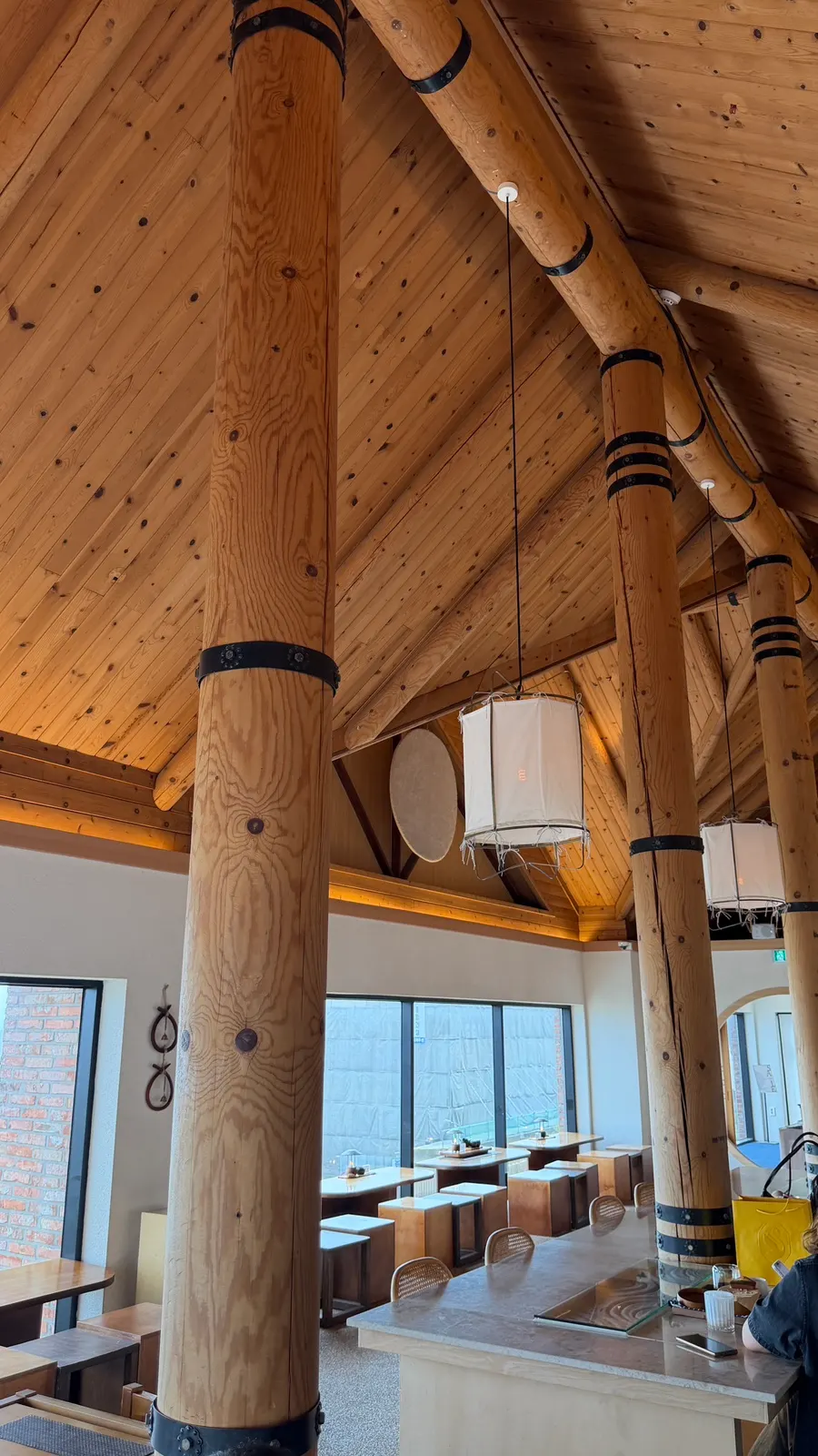 Hanok-style interior with log pillars and a wooden roof