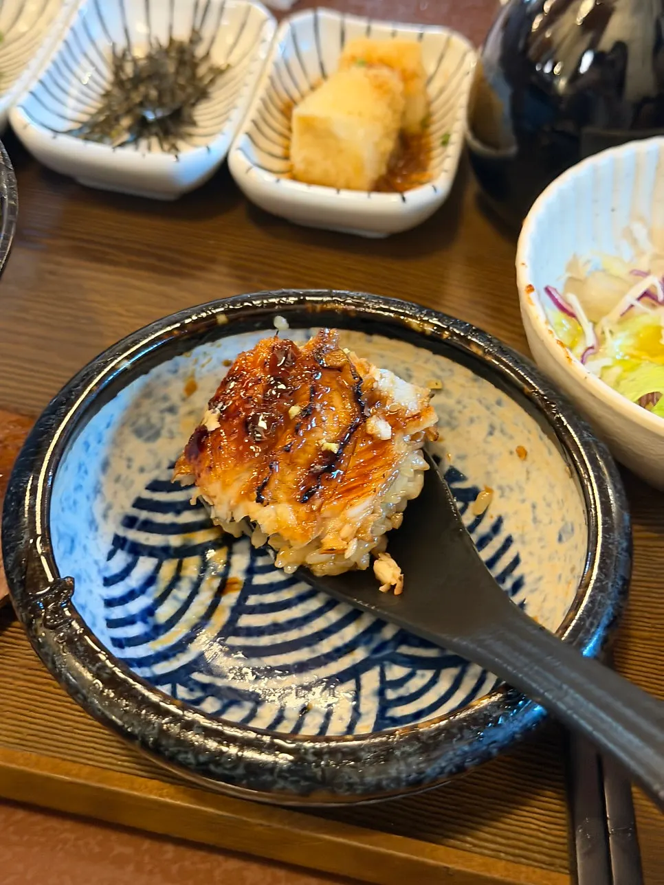 Eel rice bowl topped with wasabi and scallions
