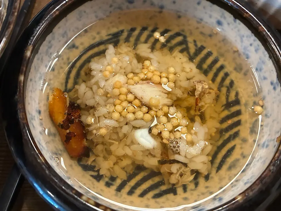 A spoonful of the mackerel bowl topped with wasabi