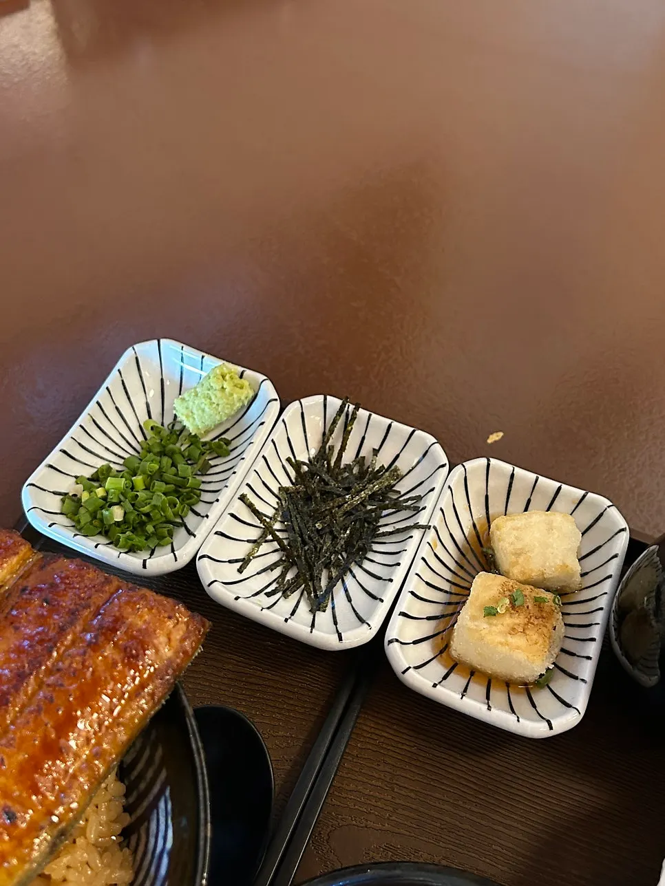 Scallions, wasabi, seaweed and tofu served alongside the unaju