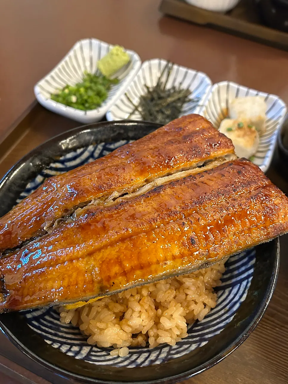 Cutting the eel with a wooden paddle