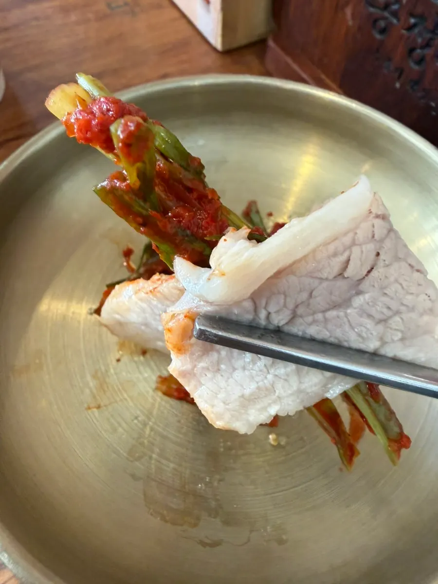 Bossam bite topped with green onion kimchi