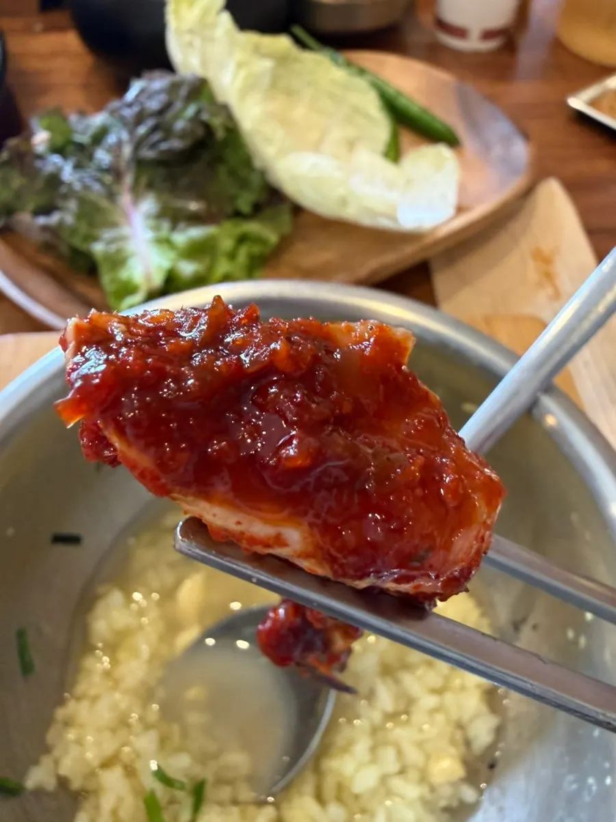 Seasoned crab spooned onto nurungji scorched rice