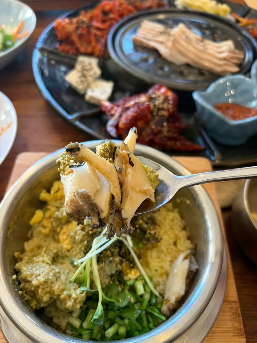 A bowl of abalone pot rice with side dishes