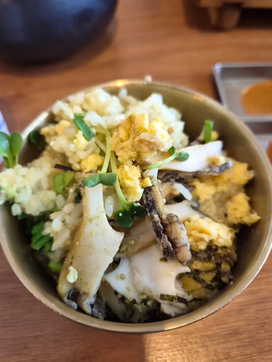 Scooping out the freshly cooked abalone pot rice