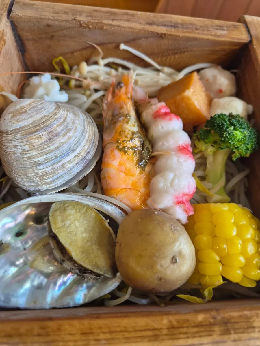 A tray of seafood in the seafood hinoki steam