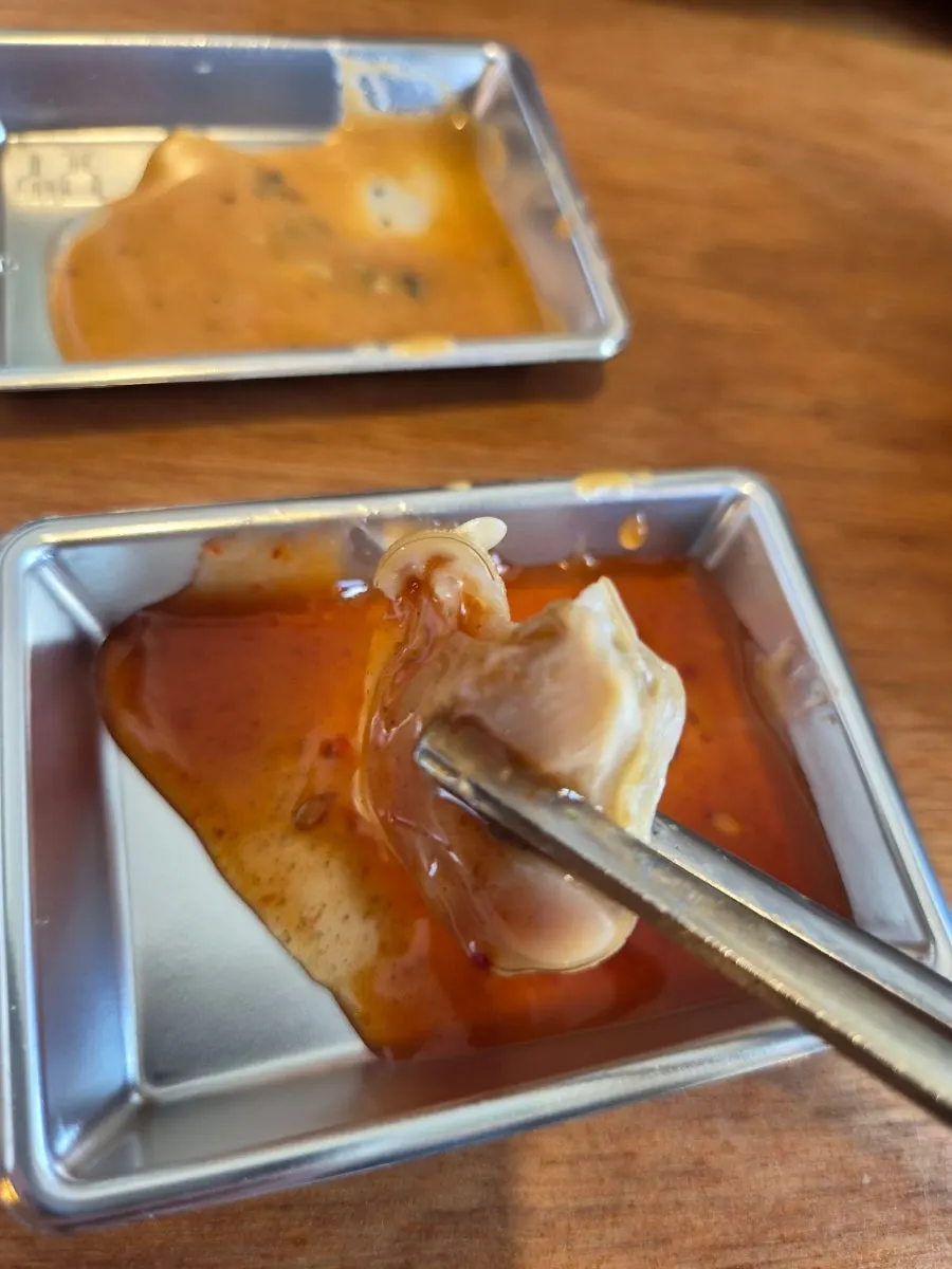 Picking up a piece of seafood from the hinoki steam