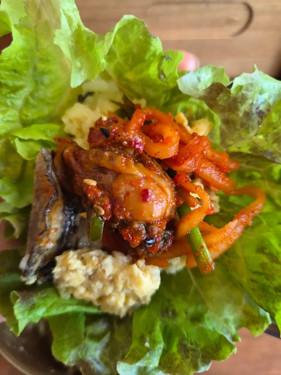 Small square dishes of peanut sauce and sweet chili sauce