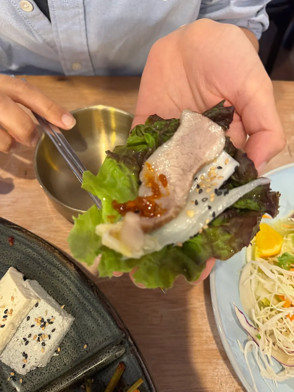 Bossam wrapped in a lettuce leaf
