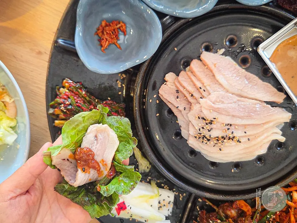 Plate of bossam kimchi, green onion kimchi and other side dishes
