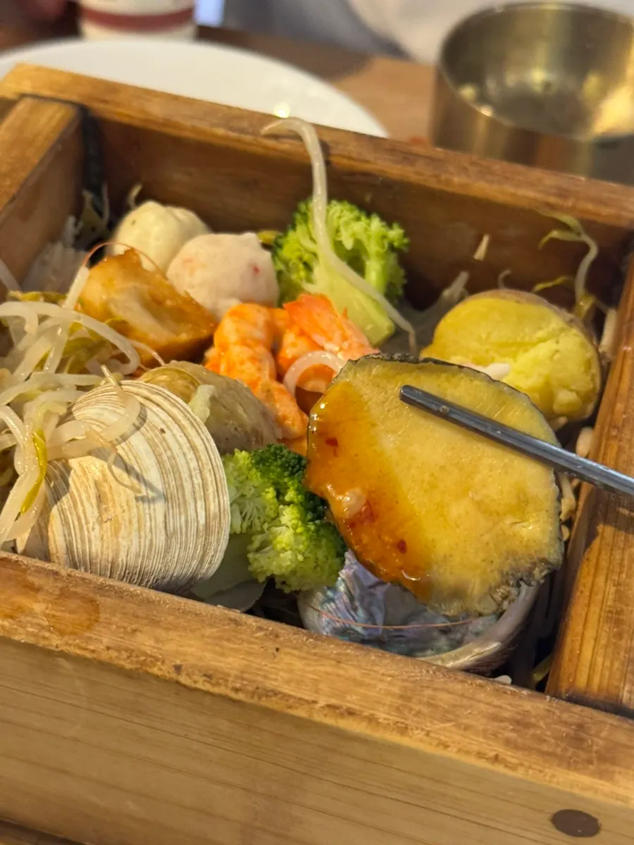 A bite of bossam wrapped in lettuce