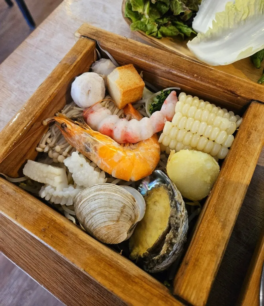 Abalone seafood hinoki steam served in a wooden steaming pot