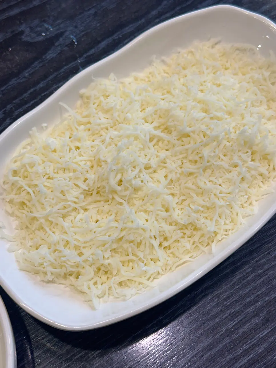 A plate piled high with finely shredded snow cheese