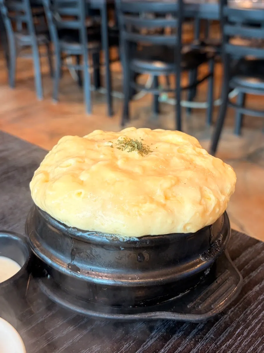Puffed-up steamed egg served in an earthenware pot