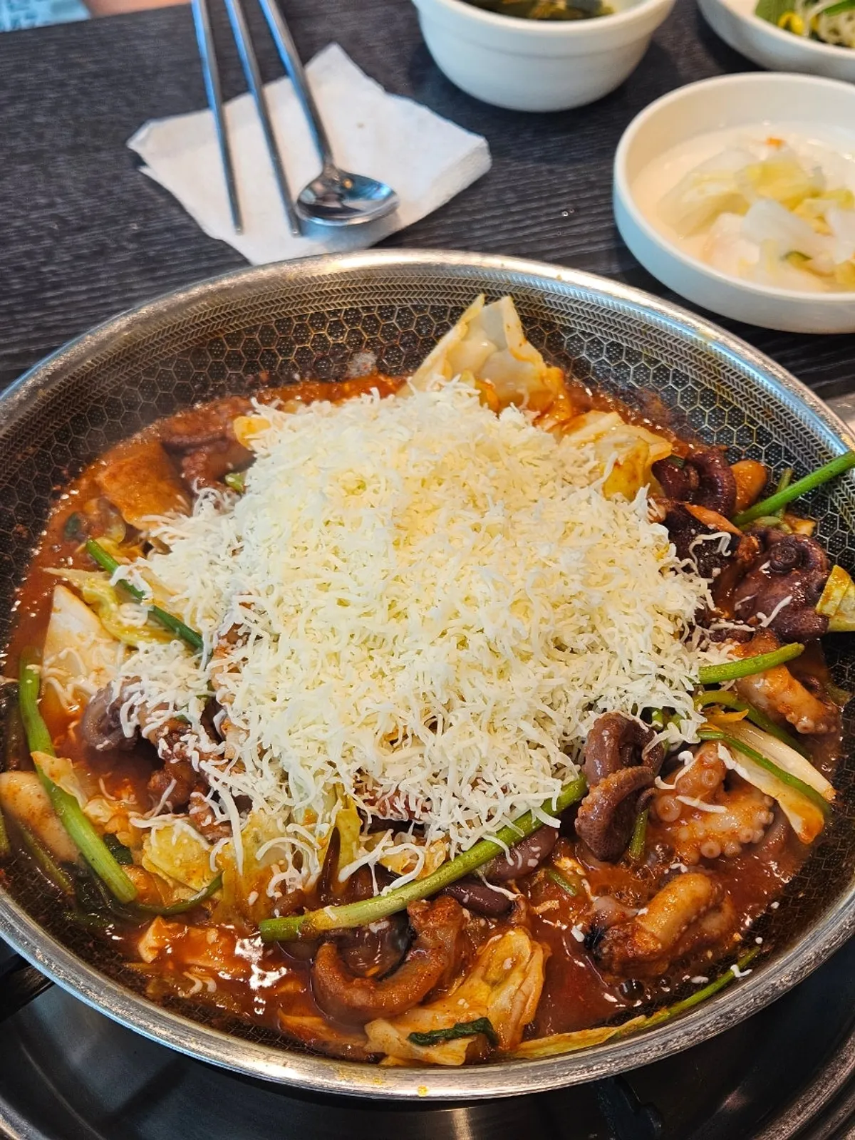 A pan of octopus covered in melting snow cheese