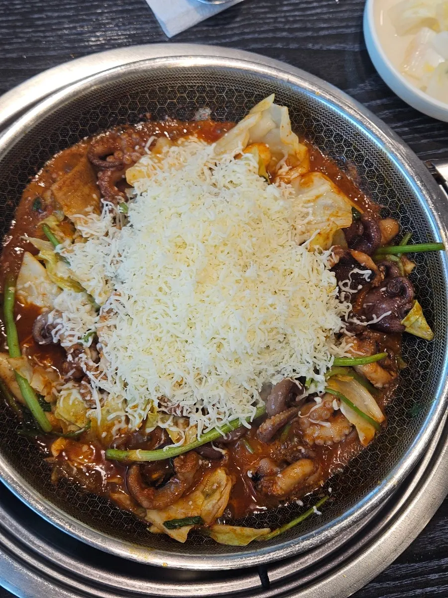 Picking up melted cheese together with octopus