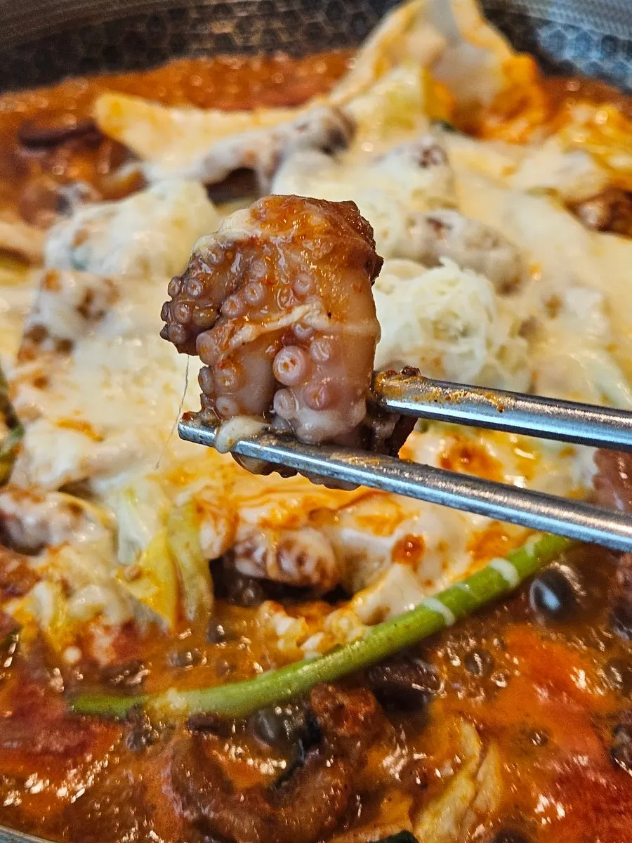 A bite combining vegetables and octopus together