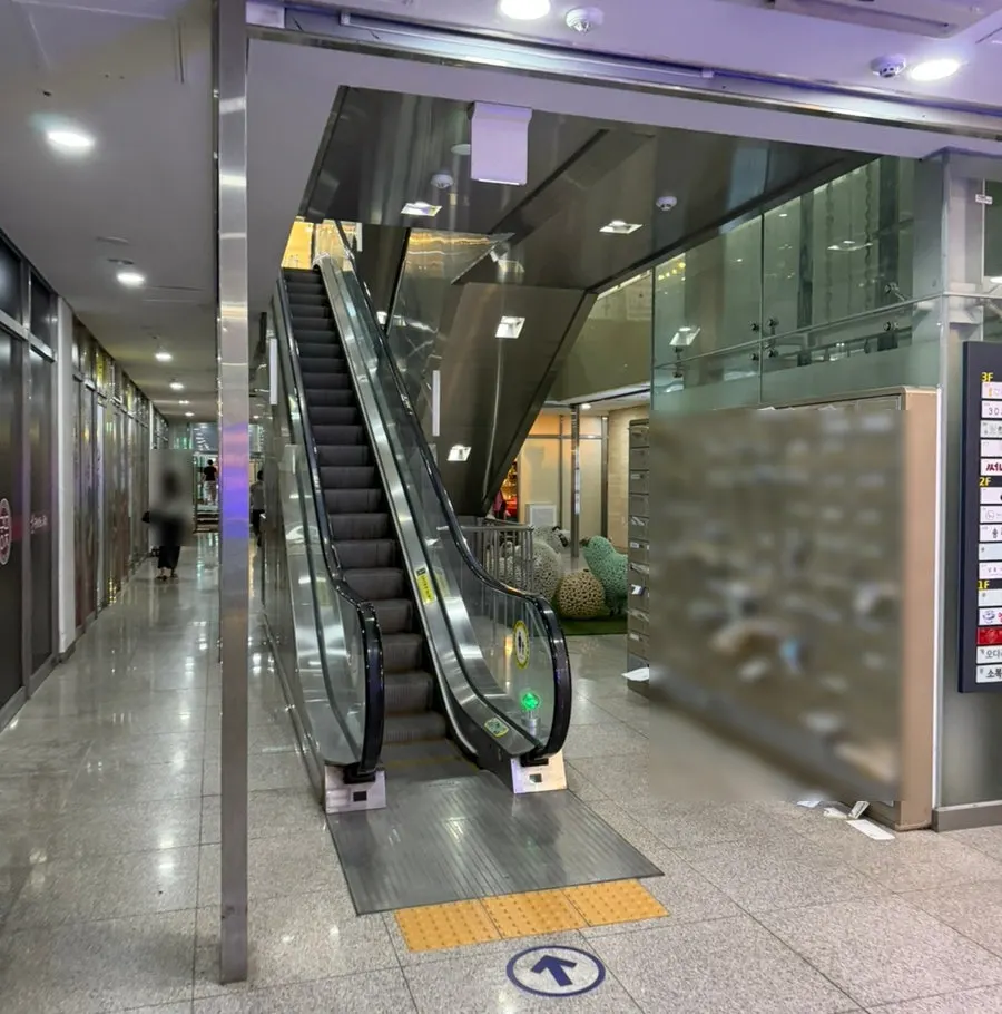 Escalator up to the 2nd floor entrance from the front of Central Tower 2
